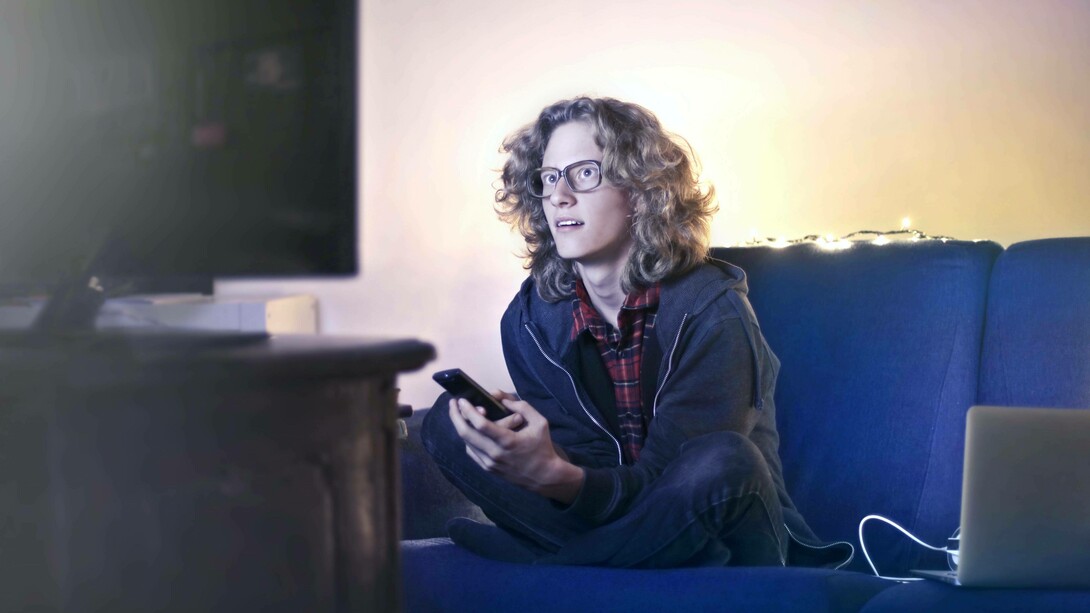 Man gazes at a TV screen