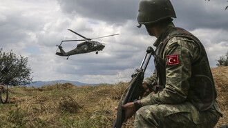 A Turkish soldier, with Multinational Battle Group-East, watches as a UH-60 Black Hawk gets ready to land after receiving a 9-line call for a simulated casualty. U.S. and NATO forces have contributed to the United Nations-mandated peacekeeping mission in Kosovo since June 1999