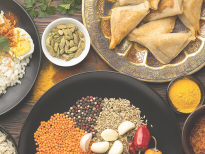 Experience the beauty of Indian saris and the flavors of Indian cuisine on display, celebrating the country's rich cultural heritage through its fashion and culinary arts
