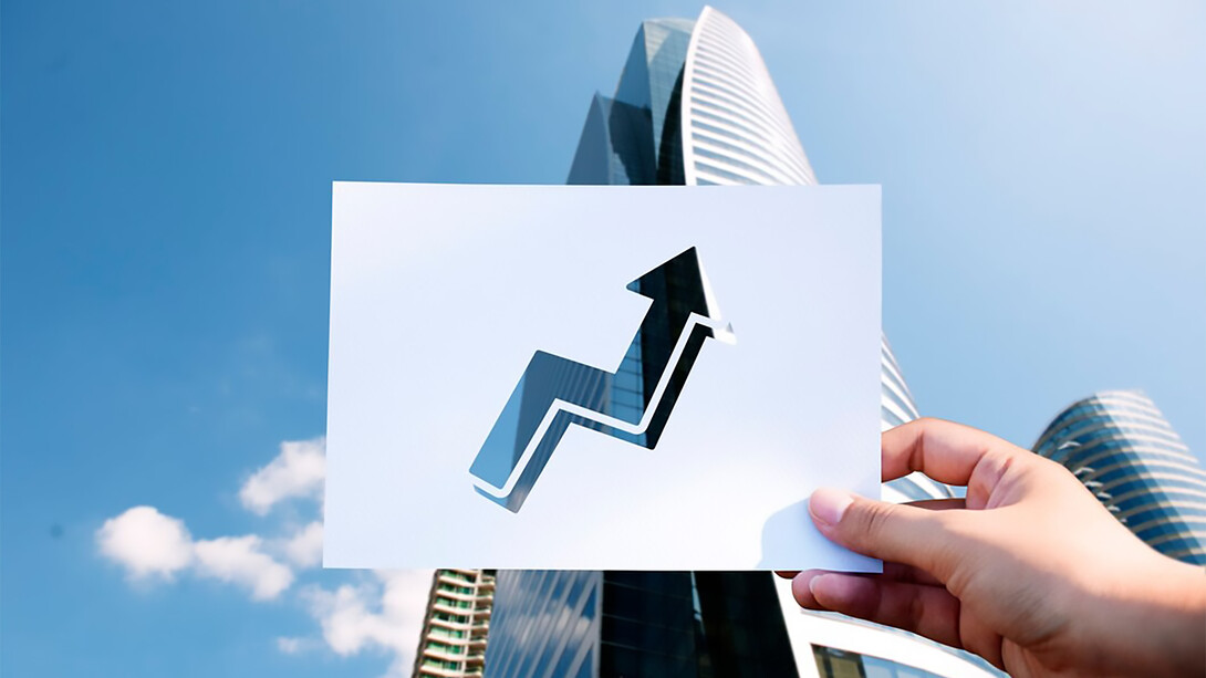 Goals and aspirations are represented on a perforated paper graph in front of a skyscraper, symbolizing the innovation ecosystem that drives economic growth
