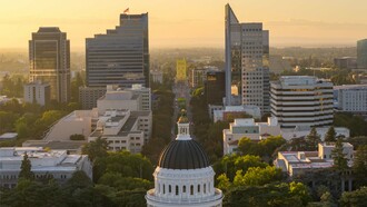 The California State Capitol rising above the city skyline in Sacramento, U.S., representing the relationship between government institutions and the forces reshaping contemporary politics