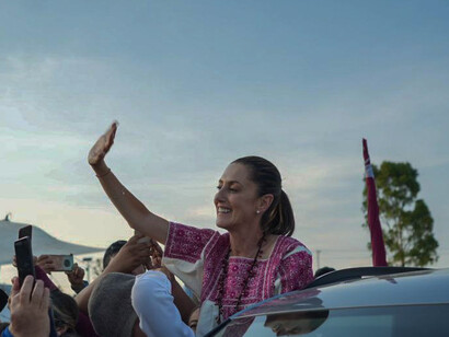 In a scene of jubilation, Claudia Sheinbaum waves to cheering crowds, signaling the dawn of a transformative presidency for Mexico