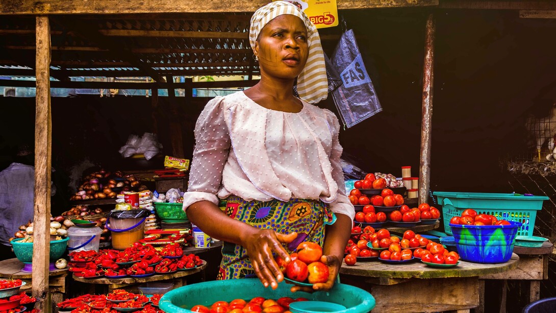 Woman selling tomatoes in a market