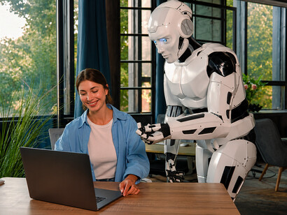 Businesswoman and humanoid robot partnering on a digital project in a modern office