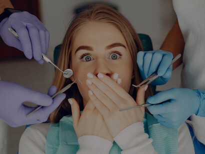 Young girl sitting in the dentist’s office, highlighting the importance of a healthy oral microbiome, with a focus on maintaining healthy teeth and gums