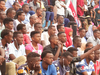 In the heart of Mogadishu, Banaadir, Somalia, a diverse assembly of Somali individuals congregates on the stands, their shared presence echoing a narrative of strength, community, and unwavering hope for a brighter future