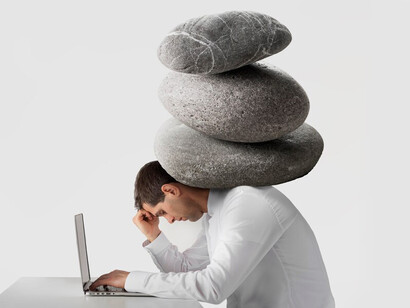 A figure weighed down by a load of rocks, illustrating the connection between personal well-being and mental filtering