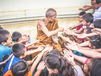 Children accepting gifts from a monk