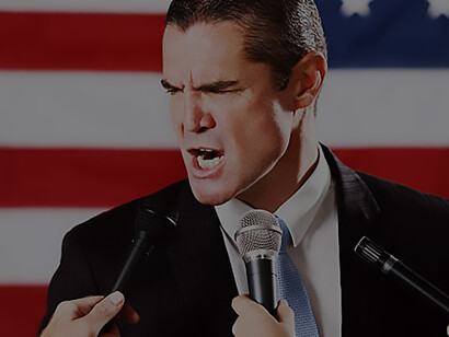 A politician, visibly incensed, engages in a heated interview with the press, expressing their frustration and discontent