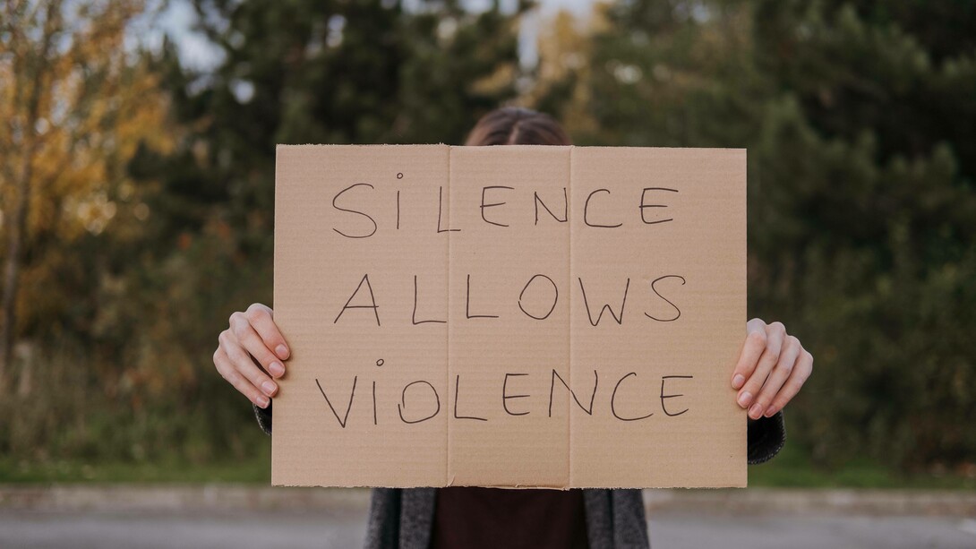 A sign pleading to speak up against injustice