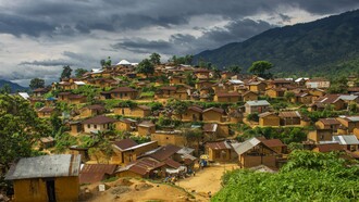 A landscape of Bitobolo village in Congo, symbolising the paradox of immense mineral wealth and persistent poverty