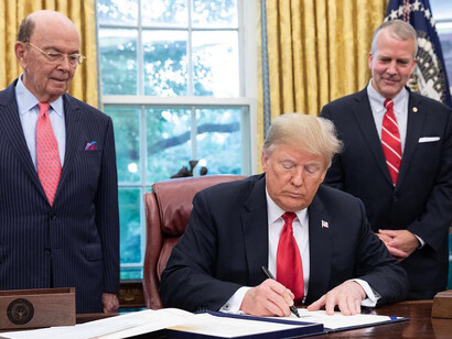 Trump signing the SOS Act at the Oval Office