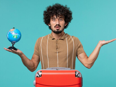 Man preparing to move overseas, holding a globe as he embarks on a new life abroad