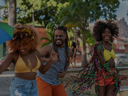 A group of vibrant Black women joyfully dancing and enjoying themselves on the lively streets