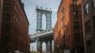 The Manhattan Bridge framed between buildings in New York City, United States