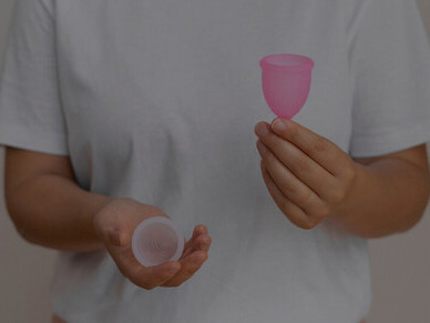Woman preparing menstrual cups, emphasizing global period poverty and the critical issues of menstrual product access, sanitation, hygiene facilities