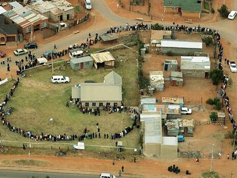 A long line of people awaiting their chance to vote bends around a corner in Diepkloof township, Johannesburg, during South Africa's fourth democratic elections on the 22nd of April, 2009