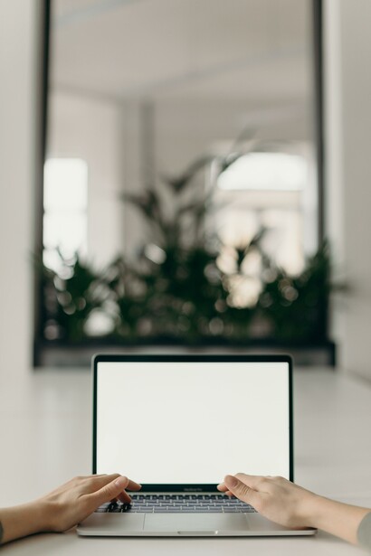 Someone typing on a laptop. Universities are adapting to fit technology