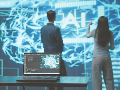 Team collaborating on laptops and tablets to solve challenges with cutting-edge AI technology