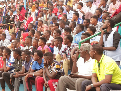 Perched on the stands of an arena in Mogadishu, Banaadir, Somalia, a lively crowd of Somali people comes together, their unity a powerful reminder of the resilience, warmth, and vibrant cultural tapestry that thrives amidst the challenges of the past