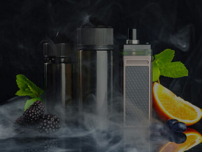 Vape and smoking liquid with fruit, set against a black background with swirling smoke