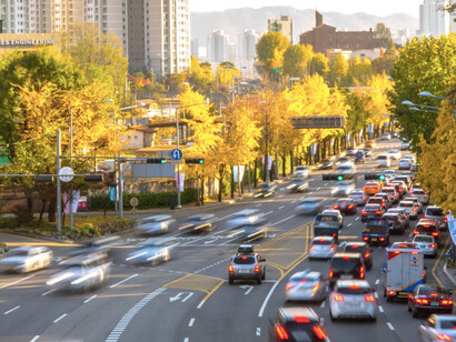 As cars weave through the chaos, the fast lane of life reveals the contradictions of individualism and conformity in a world that never slows down