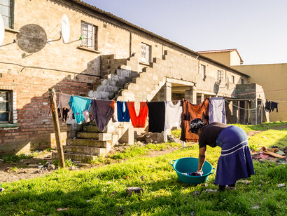 In Langa township, Cape Town, South Africa, a woman's everyday act of hanging laundry underscores the global call for resilient and dignified human settlements, resonating with the spirit of Habitat I