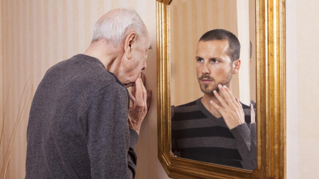 An older man looking at his younger self
