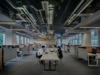 Just a few coworkers sitting on a long desk surrounded by empty cubicles in the workplace could be a sign of existential anxiety