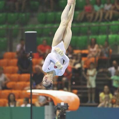 A female gymnast on the floor