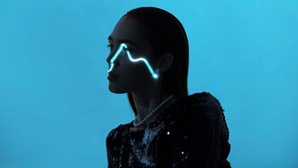 Portrait of a young woman against a vibrant blue backdrop