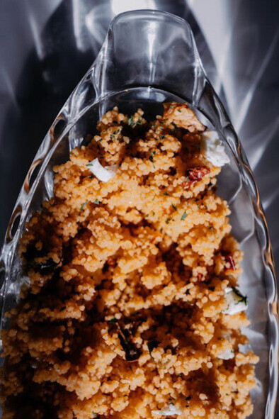 Golden grains of couscous glisten in the light, ready to complement the savoury and spiced Rfissa, a dish that celebrates Moroccan culinary traditions