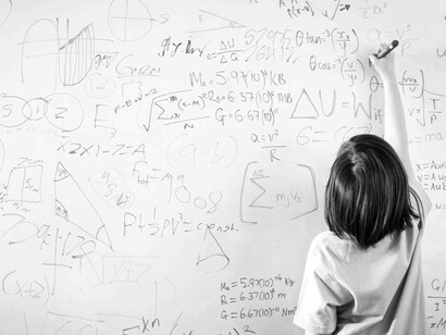 A young boy attempts to solve the math equations