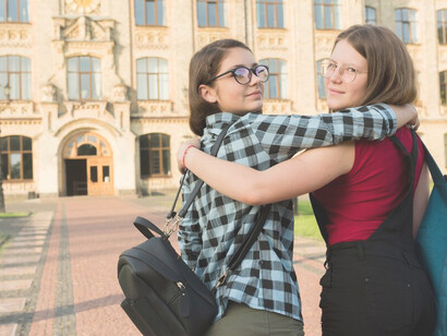 Two high school girls posing for the camera, showcasing their friendship and enthusiasm