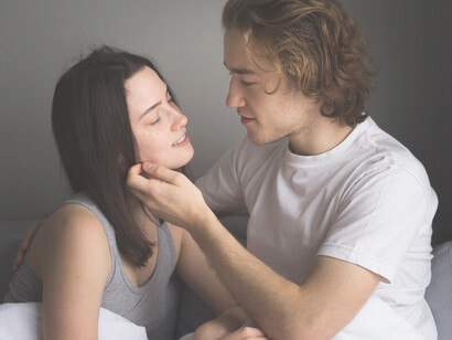 Couple sharing a close embrace in bed, showcasing intimacy and deep emotional connection in their relationship