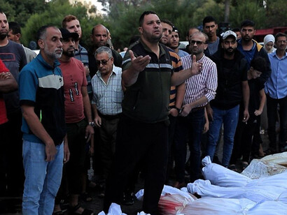 Palestinians pray over their deceased loved ones, casualties of the 2023 Gaza conflict