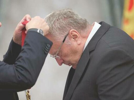 Vladimir Zhirinovsky bowing his head to receive his medal at a ceremony in Moscow, Russia