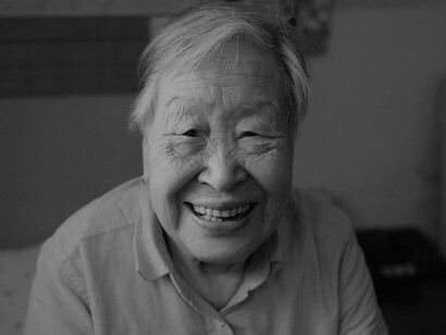 A smiling elderly Asian woman
