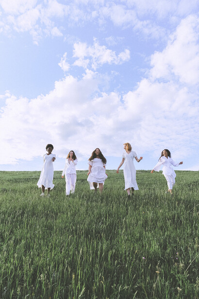 Women in white running in nature