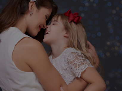 A mother and daughter enjoy a fun embrace, showcasing the beauty of maternal love