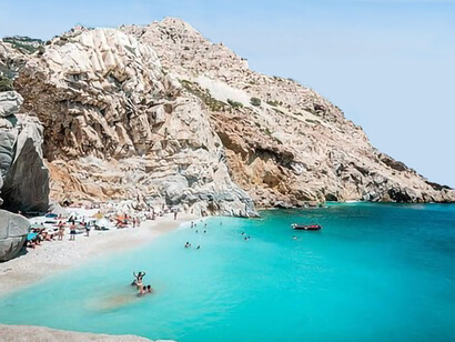 Beachgoers enjoying the shores of Ikaria, Greece