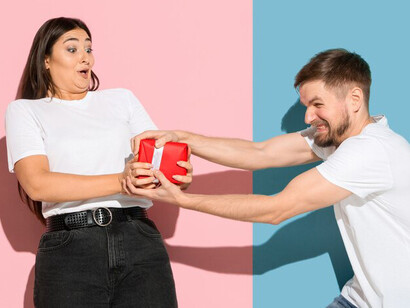 Vibrant and emotional, a young couple stands against a pink and blue wall, embodying the dynamics of relationships with happiness shining through