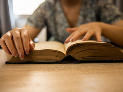 A woman reading an old novel