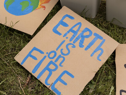 A cardboard sign calling for climate change awareness