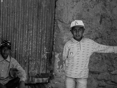 Young boys hang around in a slum