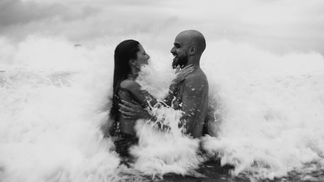Amidst the serene embrace of ocean waves, this couple embodies the volatile beauty of passion, where impulsive decisions and memories collide in a dance of love and conflict