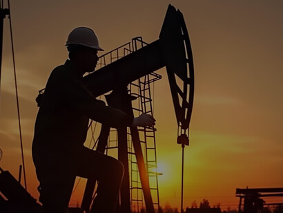 At the convergence of human labor and technological innovation with a stunning depiction of a worker and oil rig silhouetted against the sunset, crafted using generative AI technology
