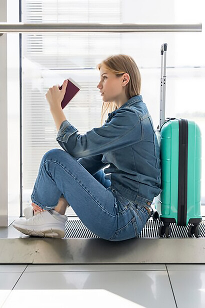 Improve your travel visuals with a striking front view of a woman patiently awaiting her flight