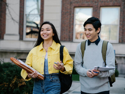 A young man and a young girl exiting their morning classes