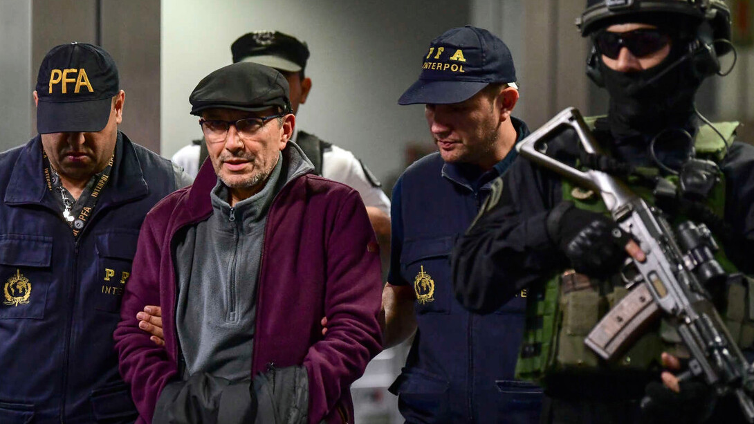 On December 16, 2019, Mario Sandoval, an ex-Argentinian police officer facing accusations of crimes against humanity from the "dirty war," is escorted by police at Ministro Pistarini International Airport in Buenos Aires after his extradition from France
